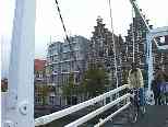 Bicyclist crossing nearby drawbridge (note step gables, and interesting nautical-theme canal houses)