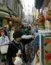 A typical street market scene in Apt, with a Provencal belfry in the background